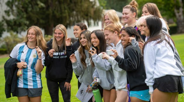 A group of first-year students pose for a picture with their acorns at Convocation, the official welcome to the new year.