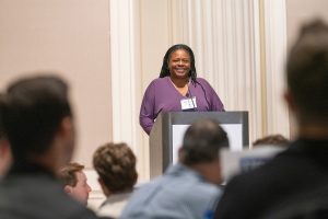 Jennifer Madden speaks at a podium.