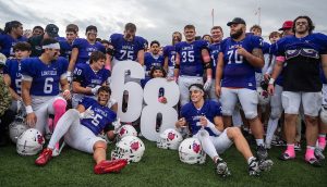 football team pose around large 68 numbers