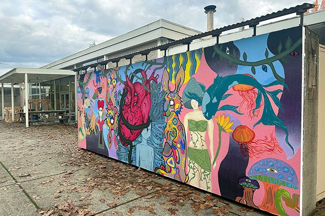 Colorful mural on a concrete wall with a heart, women, fish, a rabbit and other abstract items.