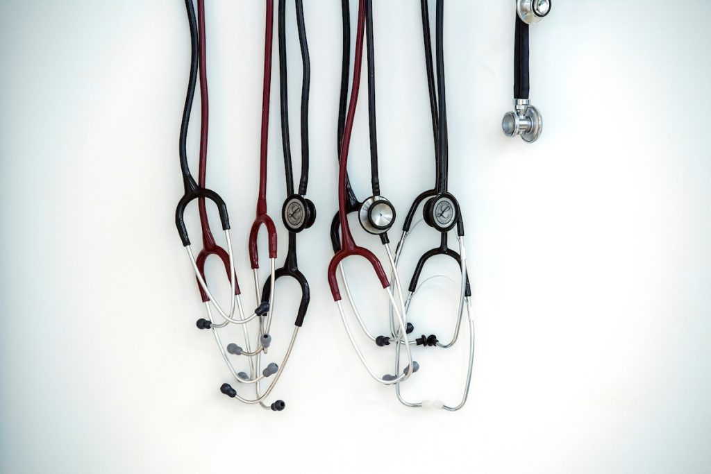 close of up stethoscopes hanging on wall