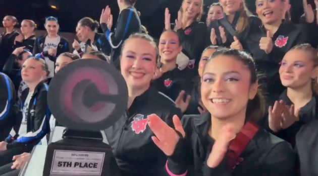 Members of the Linfield dance team hold 5th place trophy