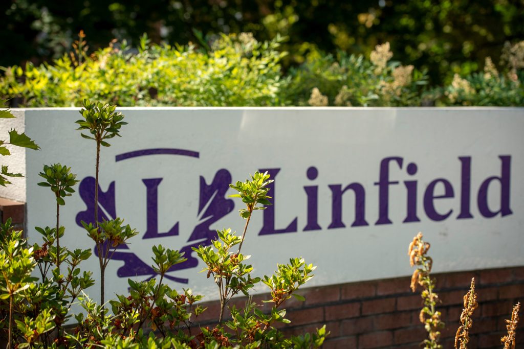 A close up of the Linfield University entrance monument