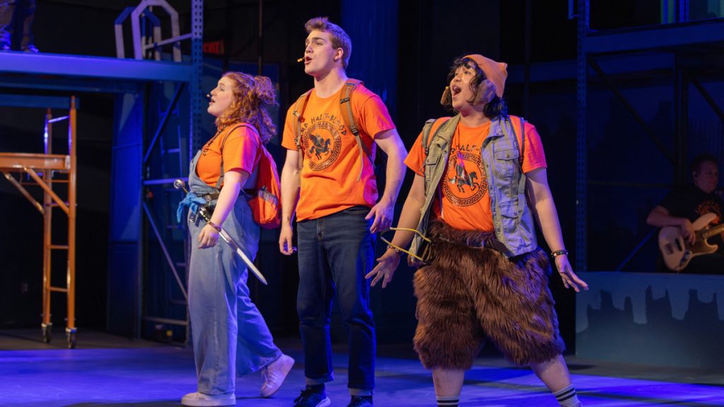 Three members of "The Lightning Thief: A Percy Jackson Musical" sing on stage.