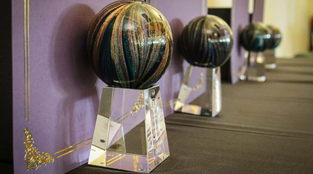 award trophies lined up down a table