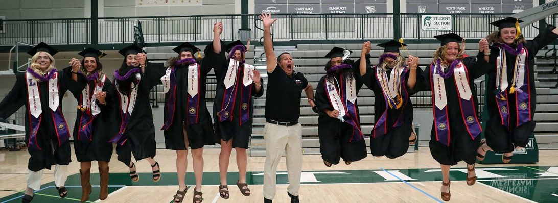 Nine softball graduates and Coach Jackson Vaughan jump in the air at mini graduation in Illinois.