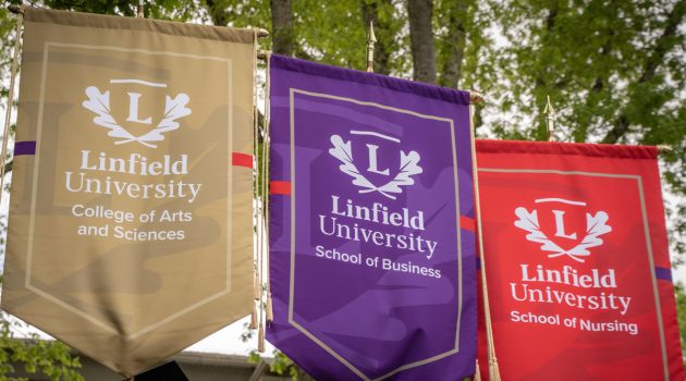 Gonfalons (large banners) for the College of Arts and Sciences, School of Business and School of Nursing.