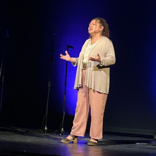 Sonia Ticas performs on stage at The Immigrant Story Live