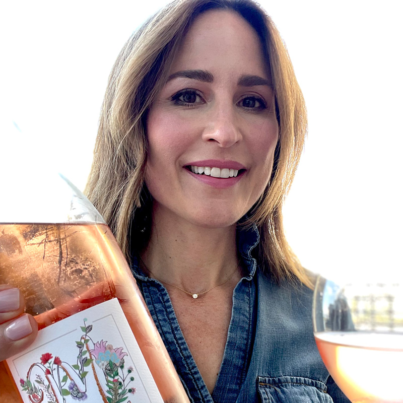 Katherine Cole holds a bottle of rosé