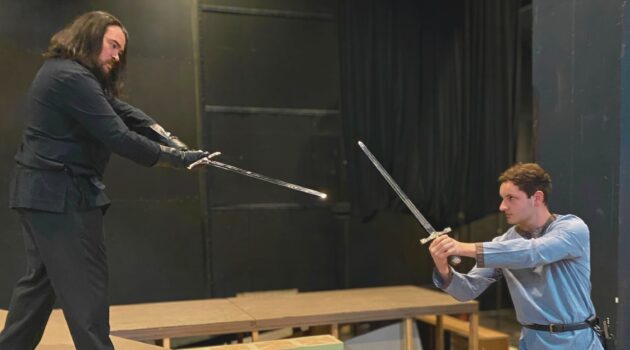 Two students rehearse "Macbeth" during a swordfight