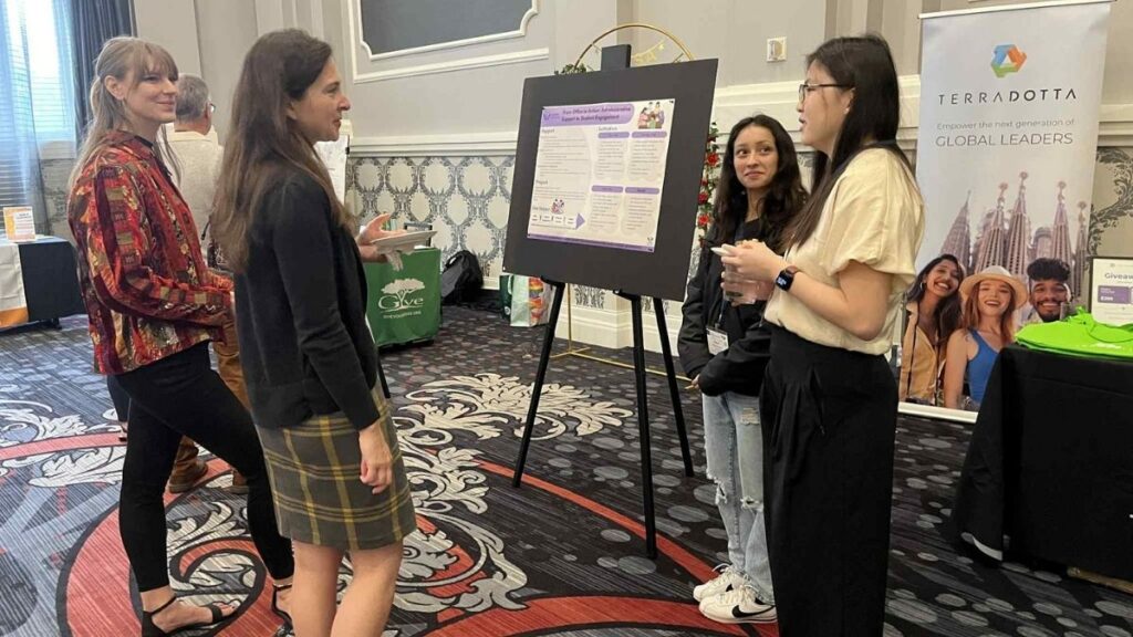 Zharyck Lopez (left) and Taila Patterson present their poster at the NAFSA Region I Conference