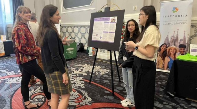 Zharyck Lopez (left) and Taila Patterson present their poster at the NAFSA Region I Conference
