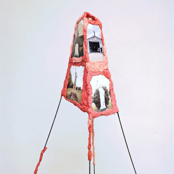 "Red 40" art by Holden Head. Easel with photos and on each side held together by pink bubble tape.