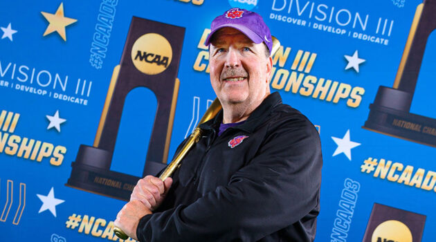 Kelly Bird poses with golden bat in front of step-and-repeat at NCAA Division III softball championships
