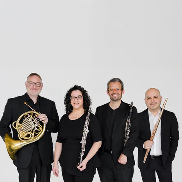 Members of Arcturus Winds pose with their instruments