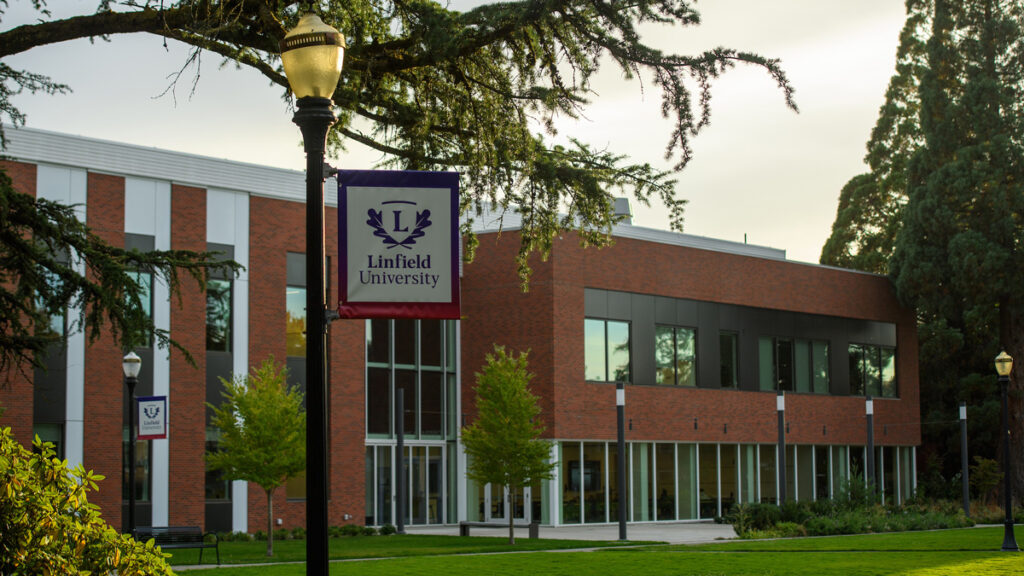 Linfield University banner on a lightpost in front of the Keck Science Center.