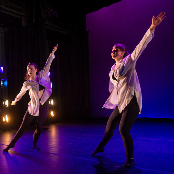 Two dancers perform on stage at the 2024 Spring Dance Showcase