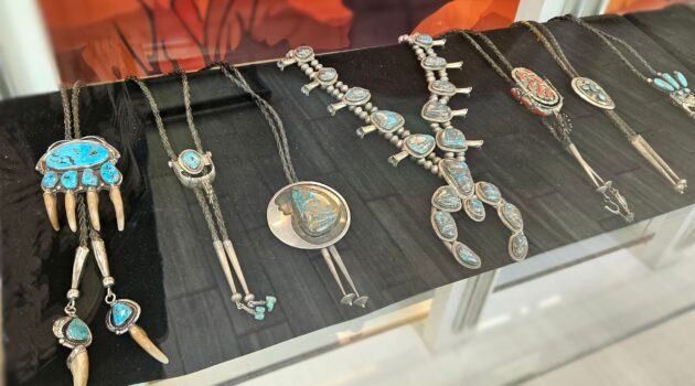 row of turquoise jewelry in a display case