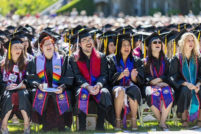 Rows of Linfield graduates sit in the Commencement Green