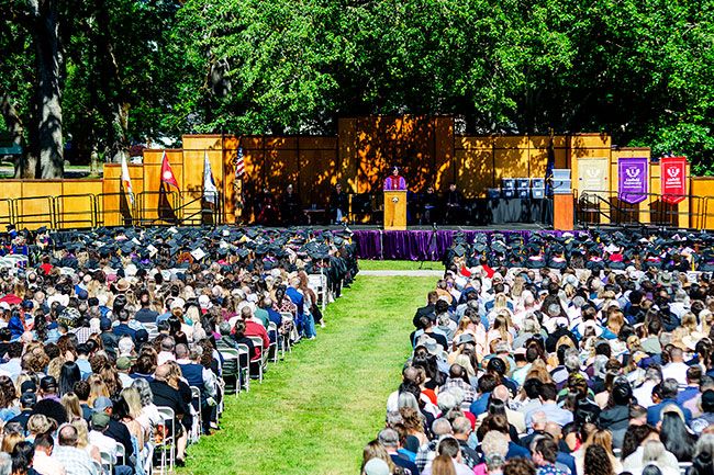 President Blegen at a podium in front of a packed crowd of commencement-goers.