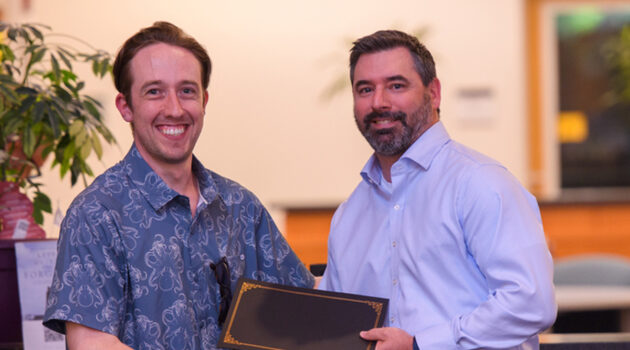 Chase Andrews receives employee award from Joe Latulippe