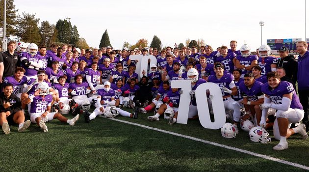 Linfield football team holds large 70s after clinching their 70th consecutive winning season.